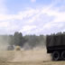 American vehicles and dust in the main arena